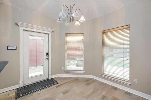 entryway featuring a notable chandelier and wood-type flooring