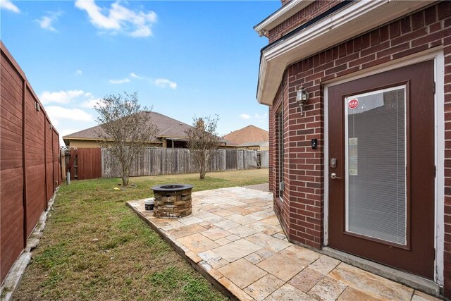 view of yard with an outdoor fire pit and a patio