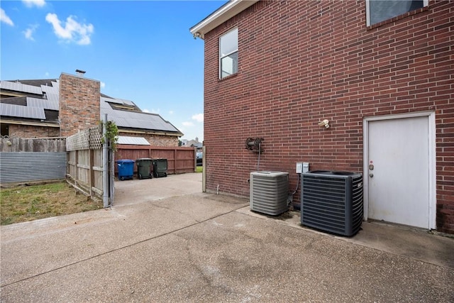 view of property exterior featuring cooling unit and a patio