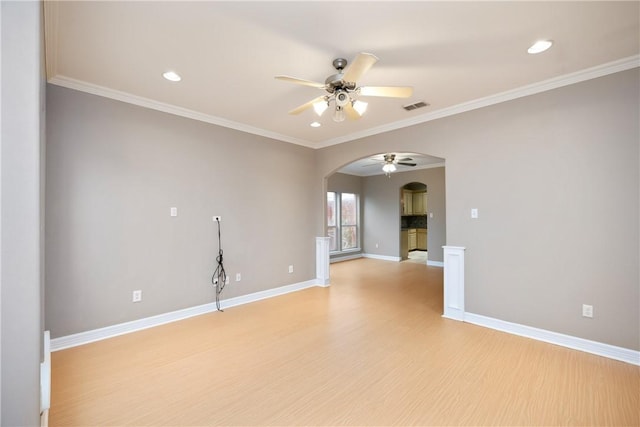 unfurnished room featuring ceiling fan, light hardwood / wood-style floors, and ornamental molding