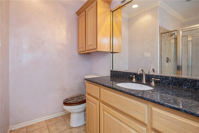 bathroom with vanity, tile patterned floors, toilet, ornamental molding, and walk in shower