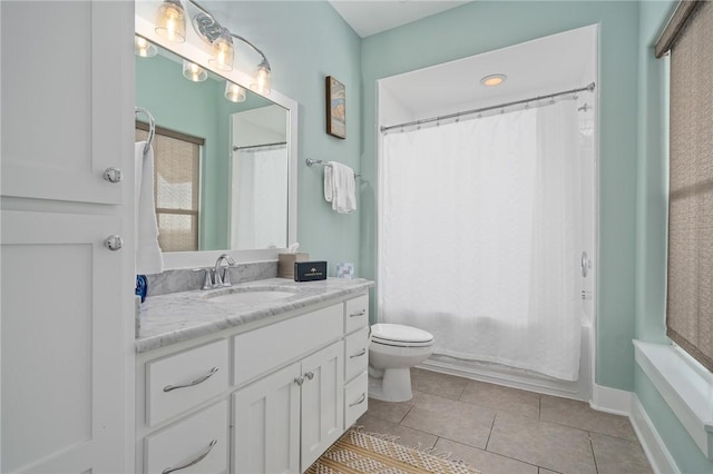 full bathroom with tile patterned floors, vanity, shower / bath combo with shower curtain, and plenty of natural light