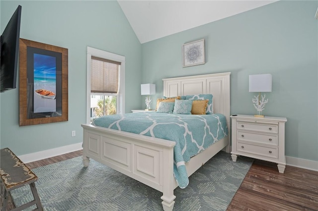 bedroom featuring dark wood-type flooring and high vaulted ceiling