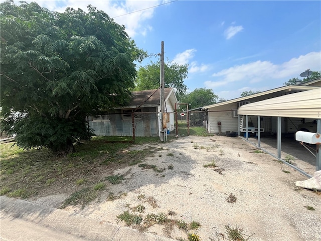 view of side of home with a carport