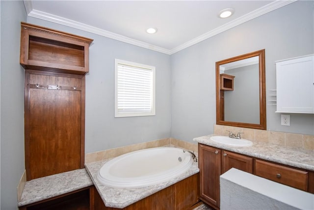 bathroom with a bath, vanity, and ornamental molding