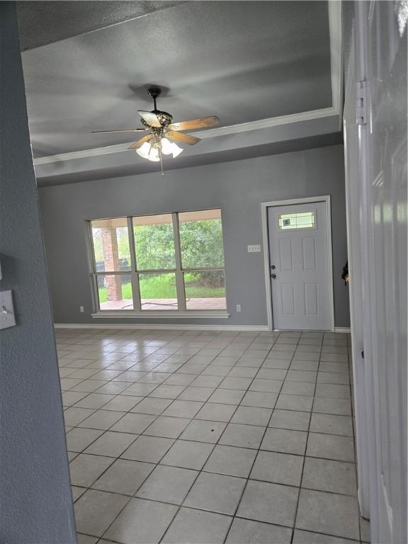 7921 Etienne Dr, Corpus Christi, TX 78414 - entryway with light tile patterned flooring, ceiling fan, a raised ceiling, and ornamental molding