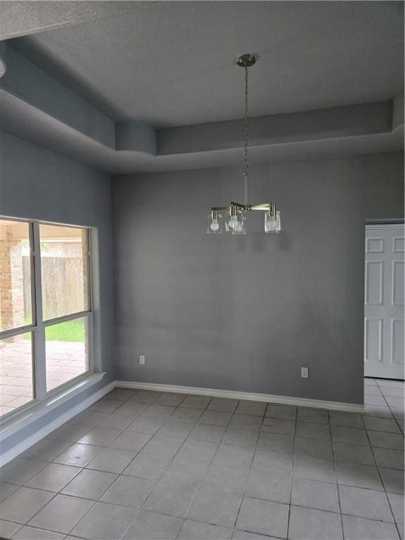 7921 Etienne Dr, Corpus Christi, TX 78414 - spare room with light tile patterned floors, a chandelier, and a raised ceiling