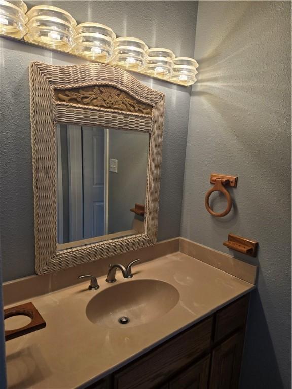 7921 Etienne Dr, Corpus Christi, TX 78414 - bathroom with vanity and a textured wall