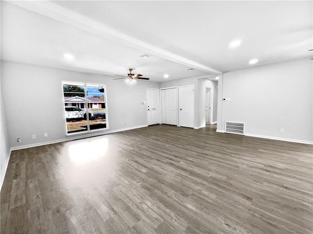 unfurnished living room featuring beamed ceiling, hardwood / wood-style flooring, and ceiling fan