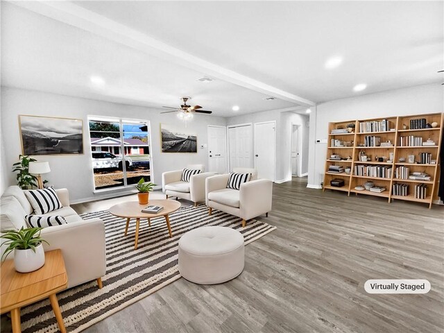 living room with light hardwood / wood-style flooring and ceiling fan