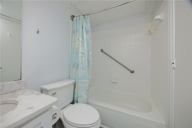 full bathroom featuring vanity, shower / bath combo with shower curtain, and toilet