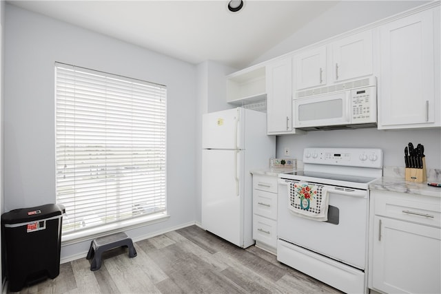 kitchen featuring white cabinets, white appliances, a healthy amount of sunlight, and vaulted ceiling