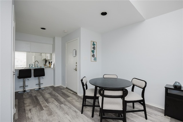 dining space featuring light wood-type flooring