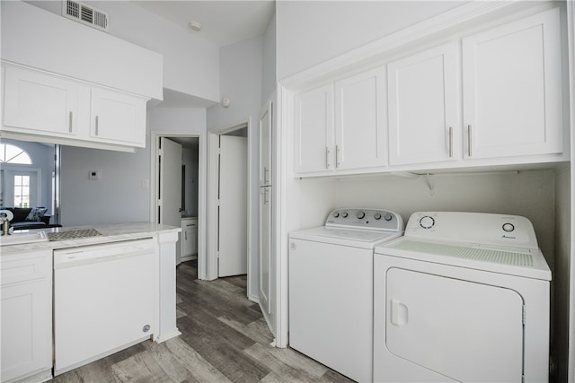 laundry area with light wood-type flooring and washing machine and clothes dryer