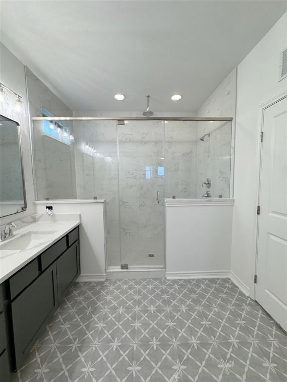 full bath featuring recessed lighting, a marble finish shower, vanity, and tile patterned floors