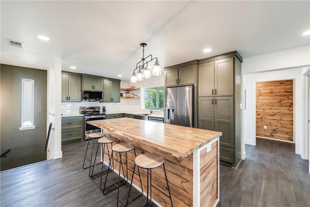 502 Corpus Christi Channel Prt, Aransas, TX 78373 - kitchen featuring stainless steel appliances, dark wood-style flooring, open shelves, recessed lighting, and hanging light fixtures