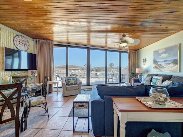 tiled living area with expansive windows, wood ceiling, and ceiling fan