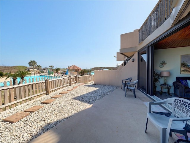 view of patio with a fenced in pool and fence