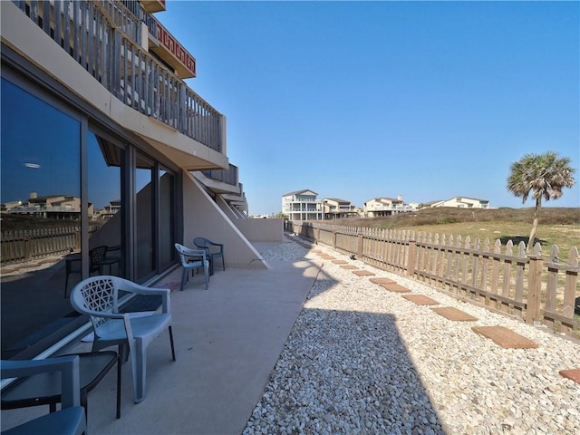 view of yard featuring a balcony and fence