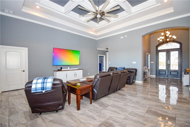 living room with ceiling fan with notable chandelier, crown molding, a high ceiling, and french doors