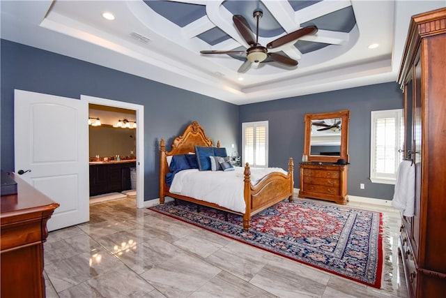 bedroom featuring a tray ceiling, ceiling fan, ensuite bathroom, and coffered ceiling