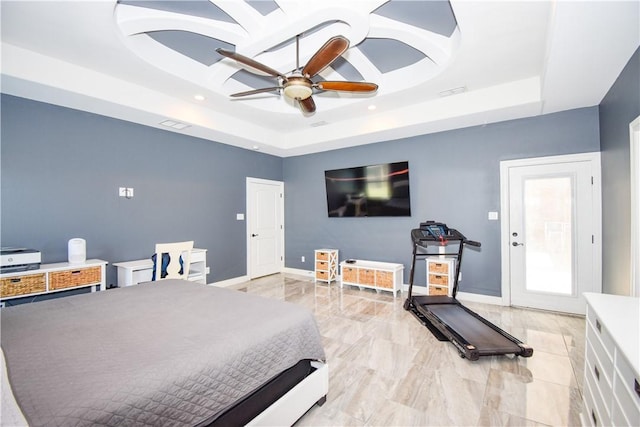 bedroom featuring a raised ceiling and ceiling fan