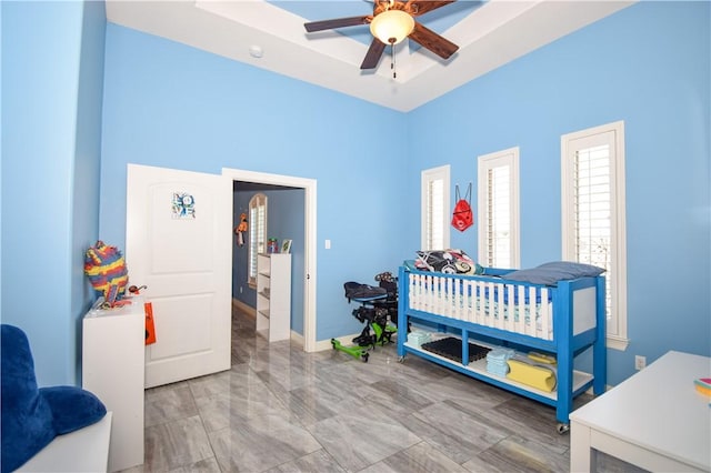 bedroom with multiple windows and ceiling fan