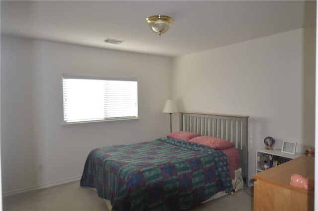 bedroom featuring carpet, visible vents, and baseboards