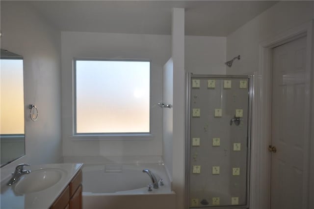 bathroom with a garden tub, a shower, and vanity