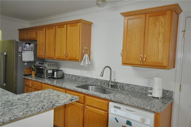 kitchen featuring white dishwasher, a sink, freestanding refrigerator, light stone countertops, and crown molding