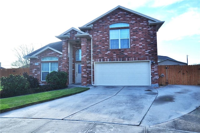 traditional-style house featuring concrete driveway, brick siding, an attached garage, and fence