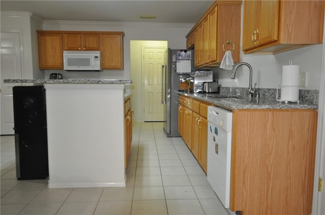 kitchen with brown cabinets, light tile patterned floors, ornamental molding, a sink, and white appliances