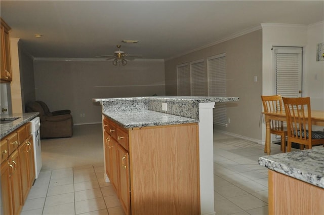 kitchen featuring light tile patterned floors, ceiling fan, a kitchen island, and ornamental molding