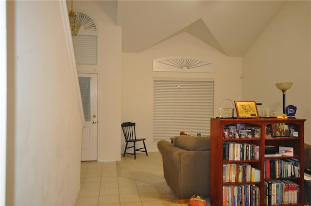 hall with vaulted ceiling and tile patterned flooring