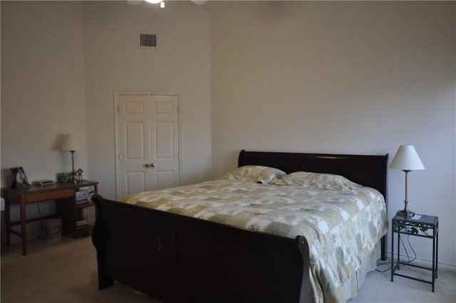 carpeted bedroom with visible vents and ceiling fan