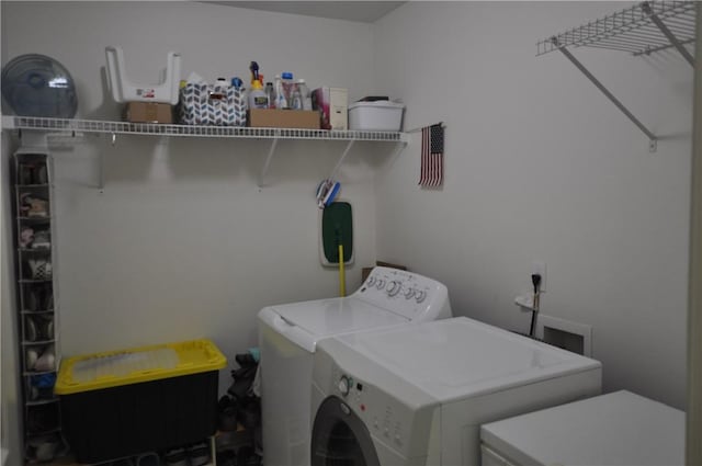 laundry room with laundry area and washing machine and clothes dryer