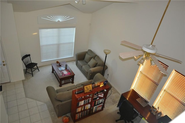 tiled living room with ceiling fan and vaulted ceiling