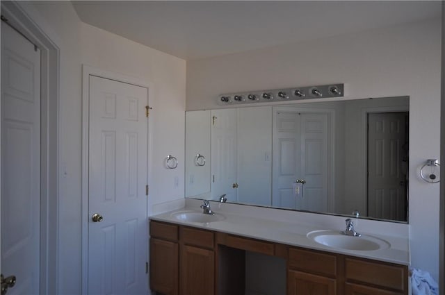 bathroom featuring a sink and double vanity