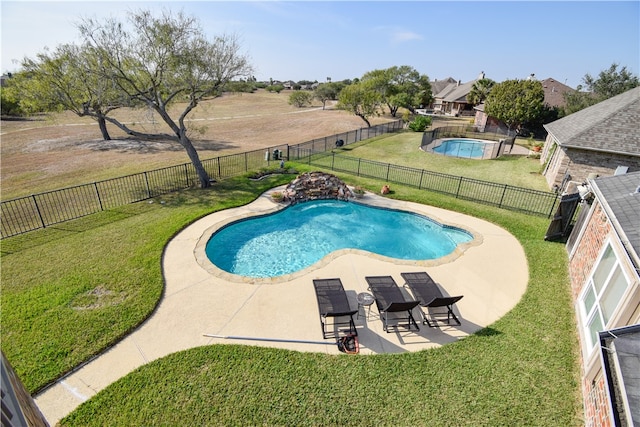 view of swimming pool featuring a patio area and a yard