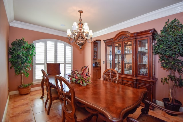 tiled dining room with a chandelier and ornamental molding