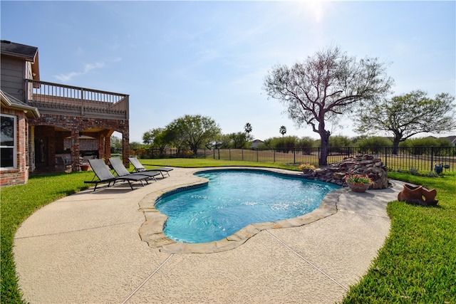 view of pool with a yard and a patio area