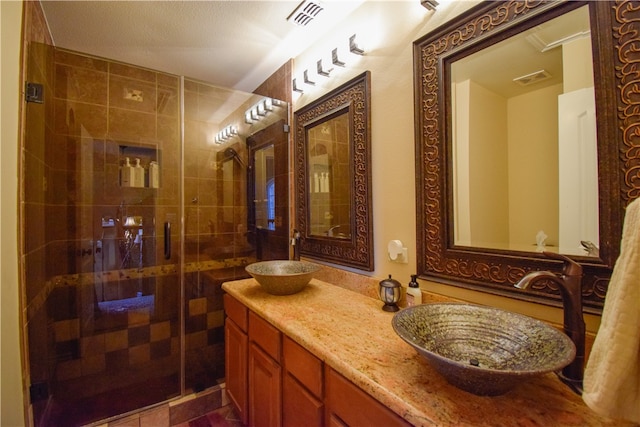 bathroom featuring vanity and an enclosed shower