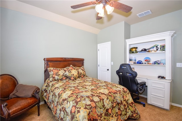 carpeted bedroom with ceiling fan and vaulted ceiling