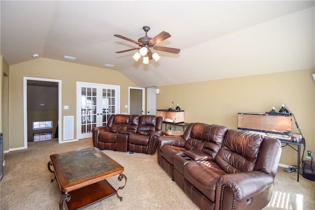 carpeted living room with ceiling fan, french doors, and vaulted ceiling