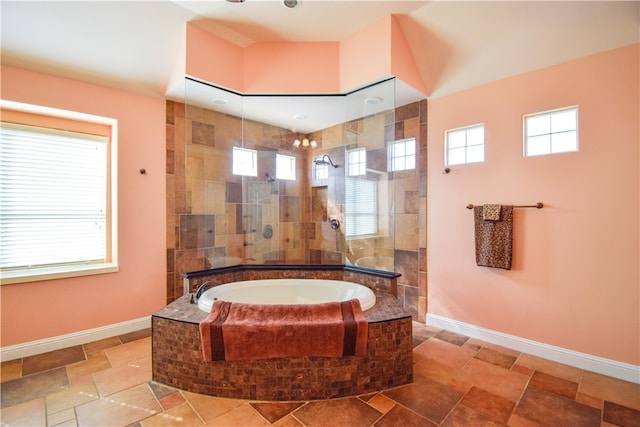 bathroom featuring shower with separate bathtub