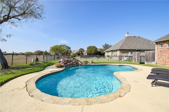 view of swimming pool featuring pool water feature and a patio