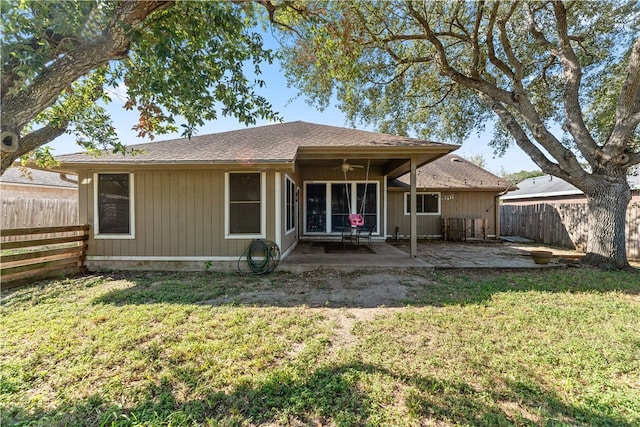 rear view of property featuring a lawn, a patio, and ceiling fan