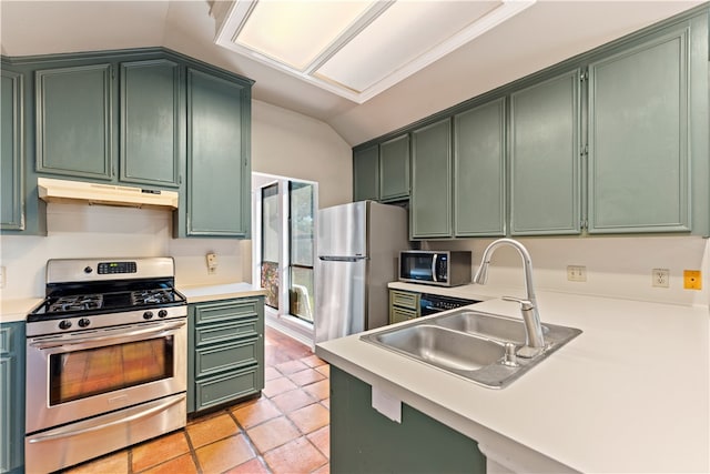 kitchen with green cabinetry, appliances with stainless steel finishes, lofted ceiling, and sink