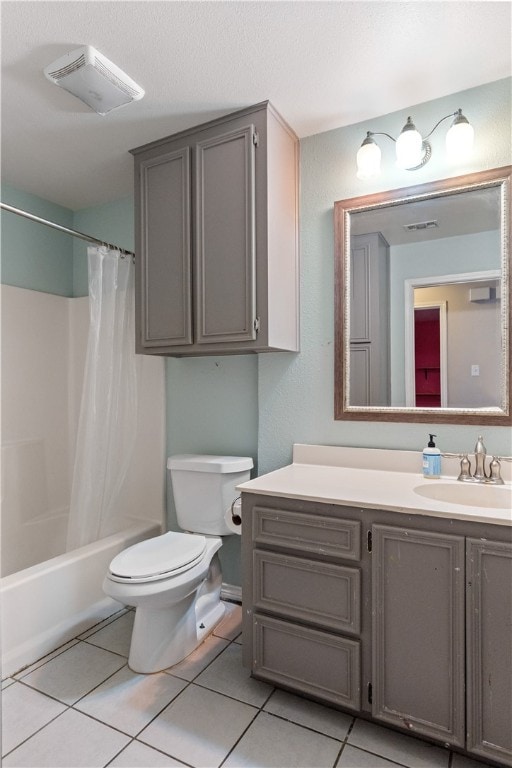 full bathroom featuring toilet, vanity, shower / bath combo with shower curtain, and tile patterned floors