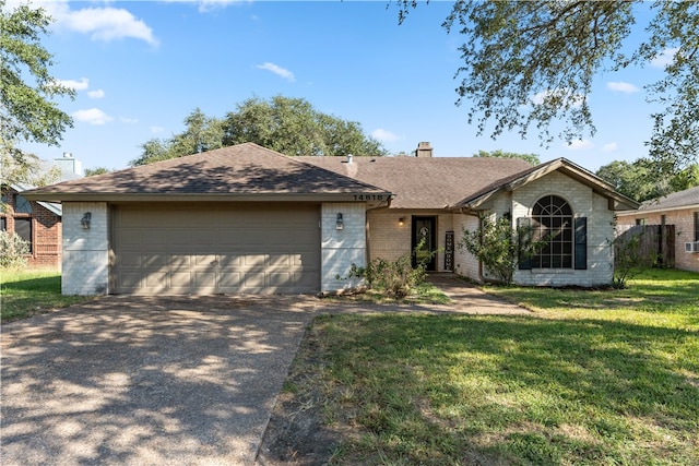 ranch-style house featuring a front lawn and a garage